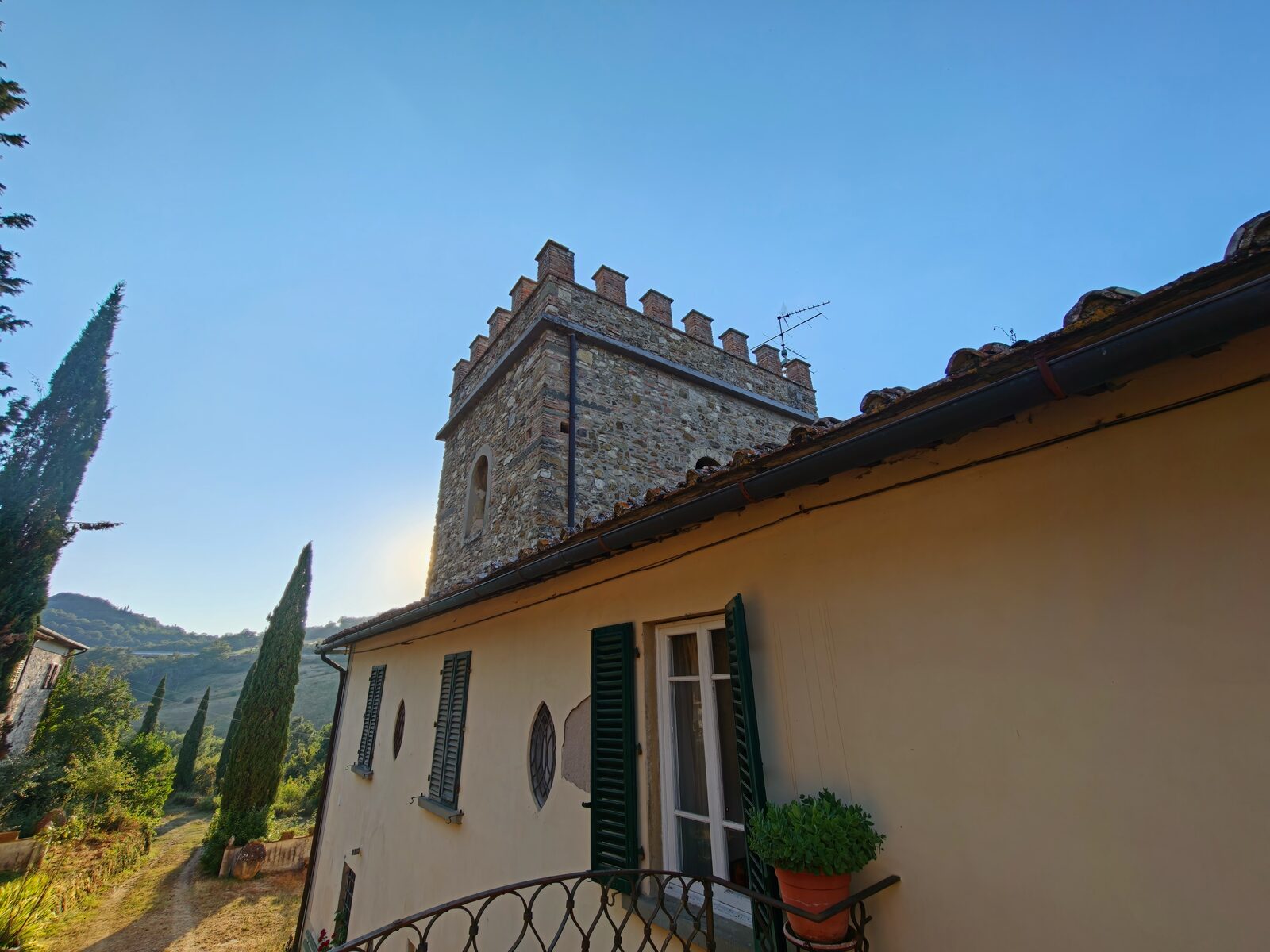 Stone tower and villa at golden hour